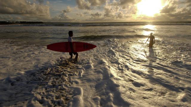 A surfer with his board at the beach