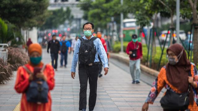 People wearing protective face masks in Indonesia as a precautionary measure against the spread of Covid-19.