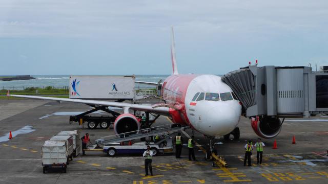 An AirAsia airplane parked at an airport in Indonesia.