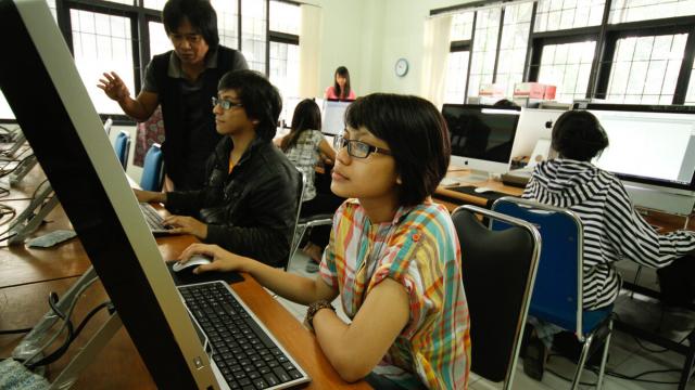 Students attending a computer class in Indonesia.