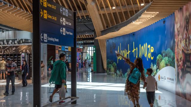 Passengers walking around an airport in the Philippines.