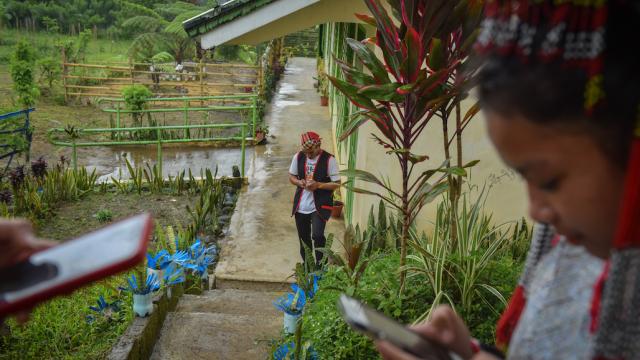 Students looking at their mobile phones while at school in Mindanao.